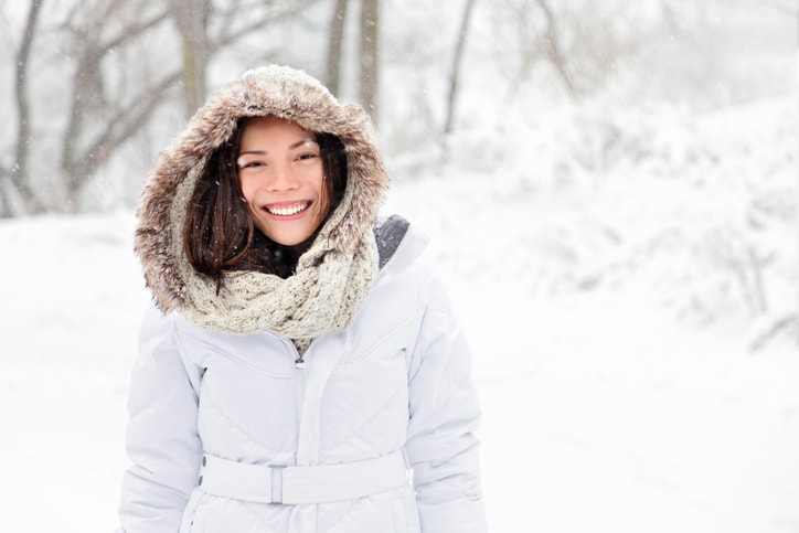 Snow winter woman wearing a Moose Knuckle winter coat