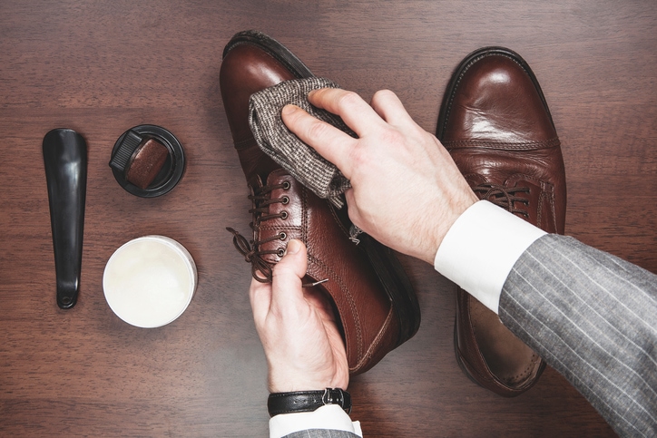Shining and polishing leather shoes business man