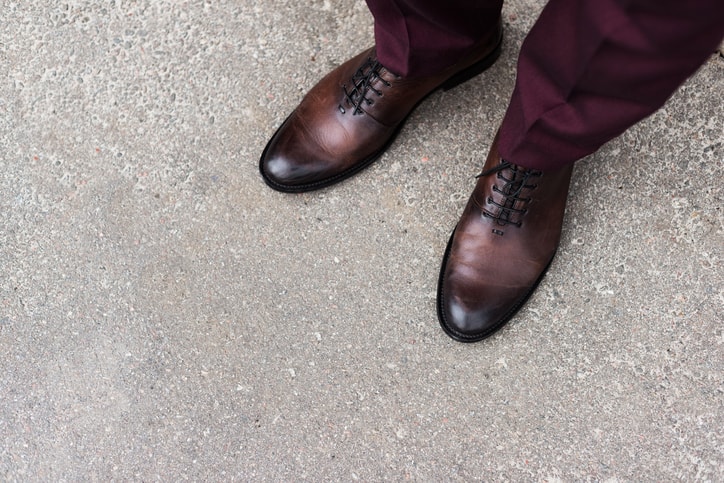 Cropped view of man wearing whole-cut leather oxford shoes